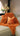 Paul Moneypenny Necking Orange Cushion