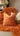 Paul Moneypenny Necking Orange Cushion