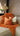 Paul Moneypenny Necking Orange Cushion