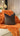 Paul Moneypenny Two Face Orange and Chocolate Cushion