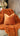 Paul Moneypenny Necking Orange Cushion