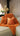 Paul Moneypenny Necking Orange Cushion