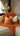 Paul Moneypenny Necking Orange Cushion